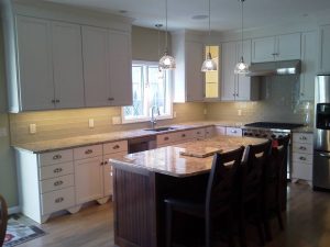 A clean, modern kitchen with white cabinets