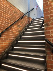 An outdoor staircase with lights installed under the steps